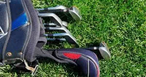 nike golf clubs laying on the grass