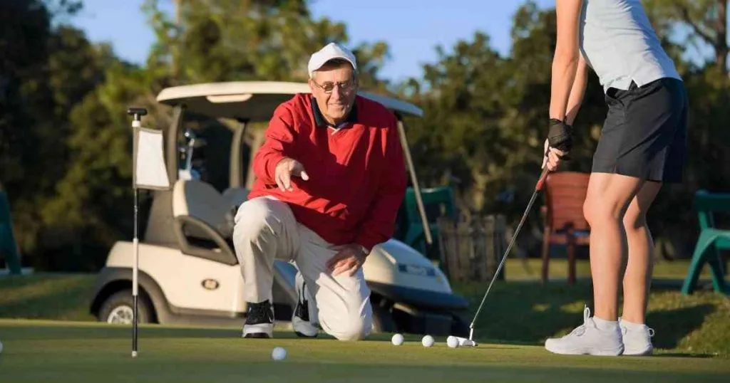 old man teaching how to aimpoint putting