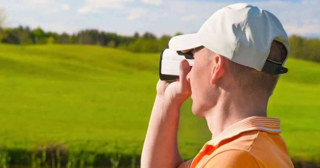 man using rangefinder