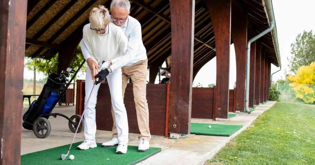 old man learning how to play golf