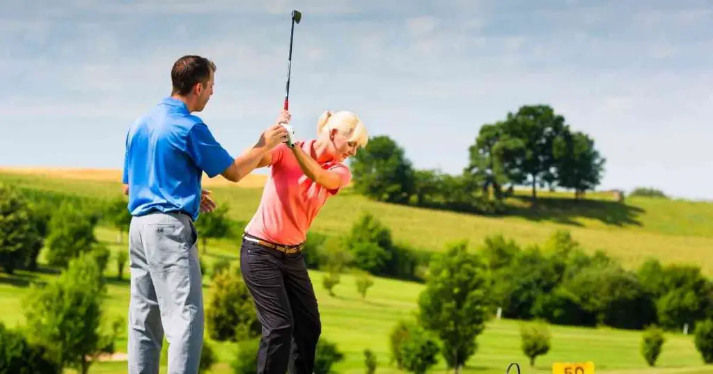 woman learning how to play golf